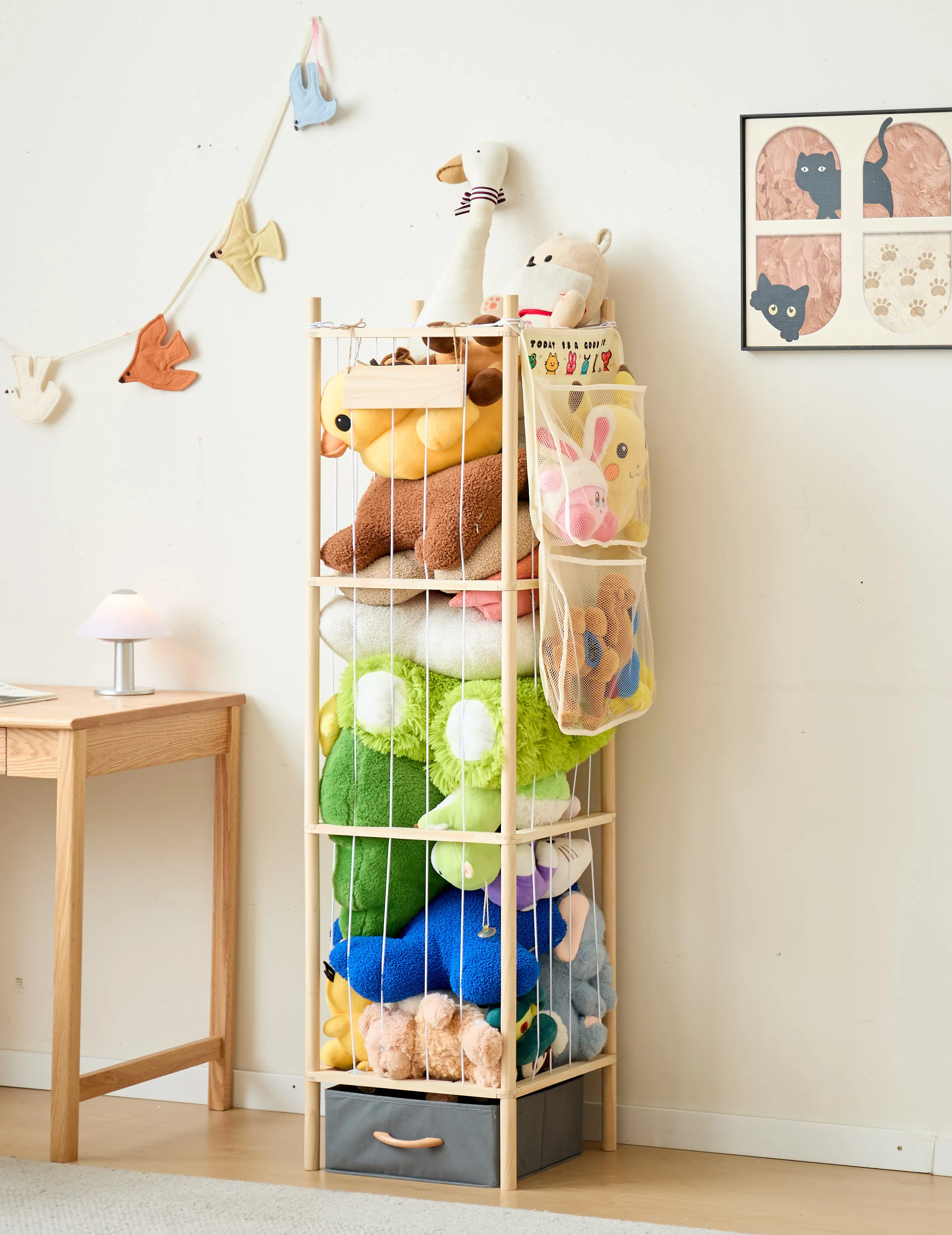 The plush organizer standing full-height and filled with soft toys in a calm bedroom